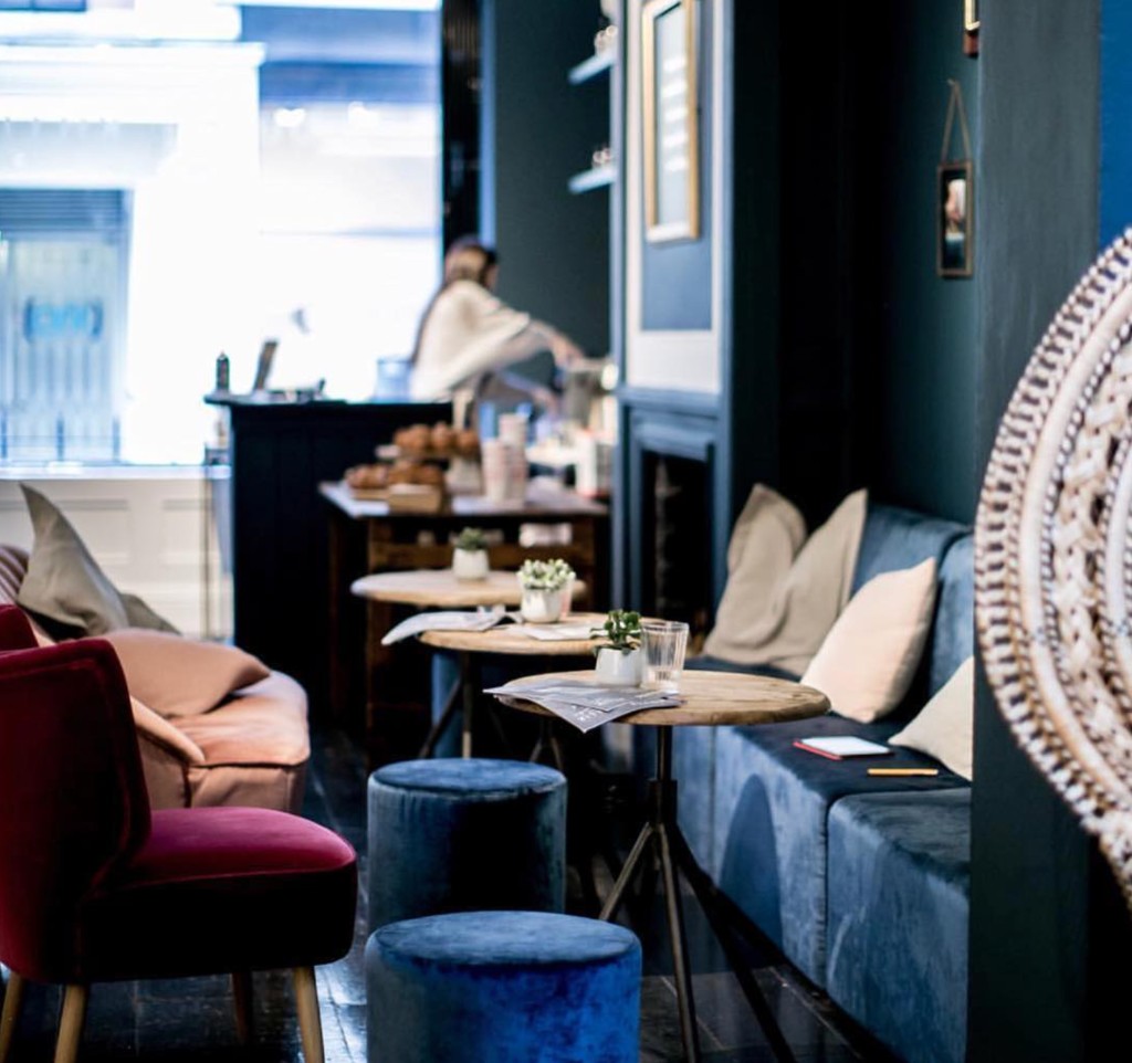 Intimate lounge at 15 Bateman Street with blue velvet seating and fireplace